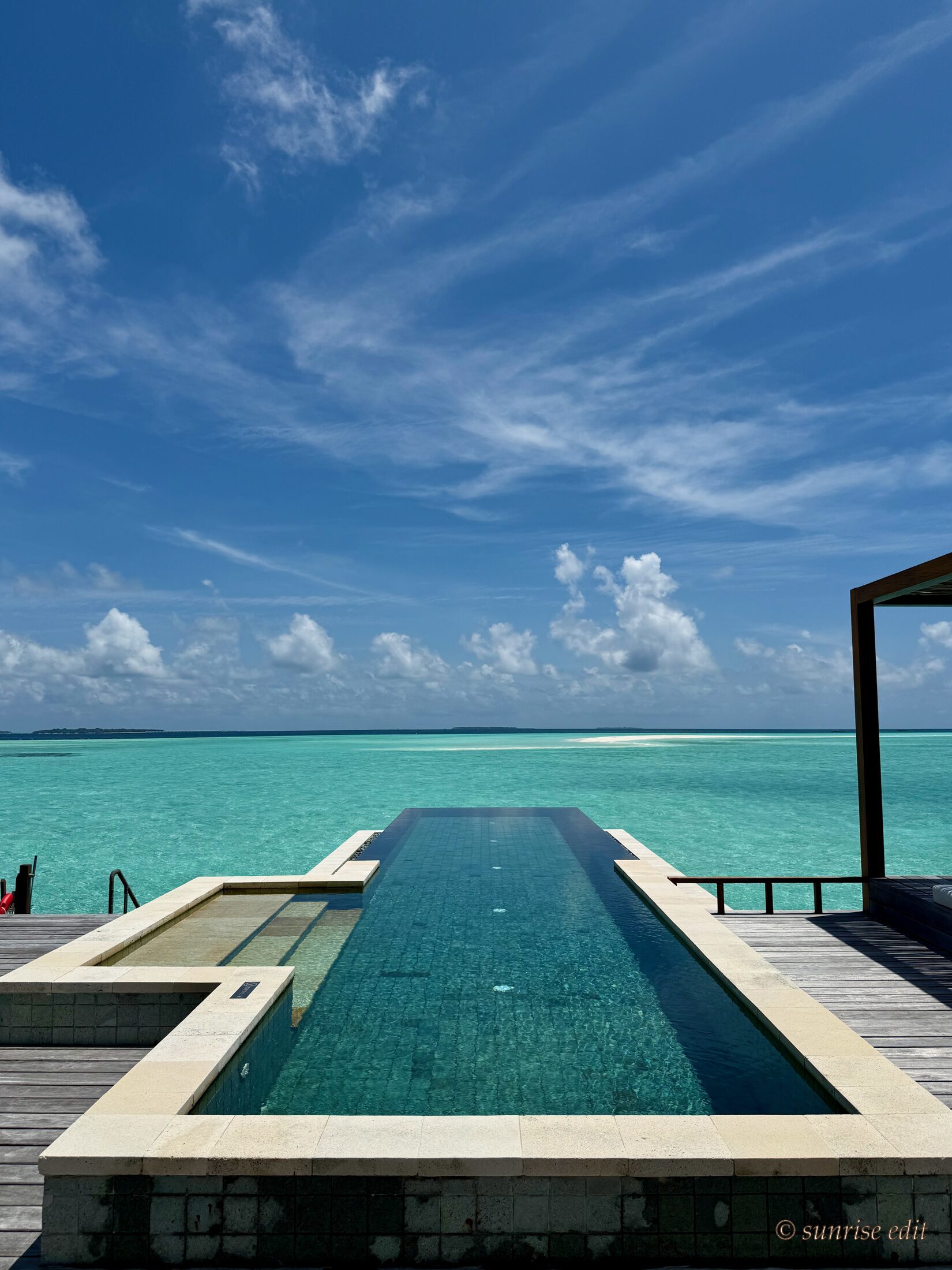 A Maldives infinity pool overlooking the turquoise lagoon